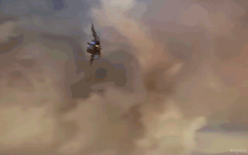 A Person Is Flying Through The Air With The Word Kepler In The Lower Right Corner GIF