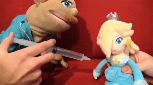 A Person Is Giving A Stuffed Animal A Syringe GIF