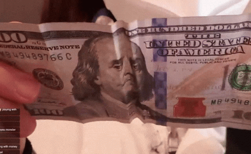A Person Is Holding A 100 Dollar Bill With The Number Mb4948 On It GIF