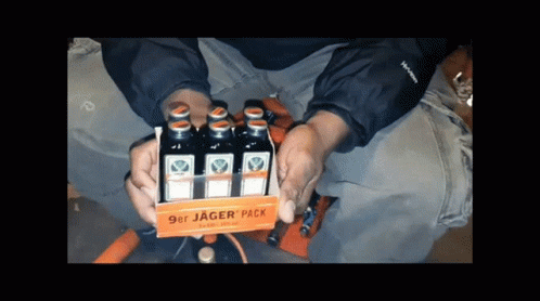 A Person Is Holding A 9Er Jager Pack Of Liquor GIF