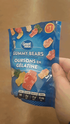 A Person Is Holding A Bag Of Gummy Bears That Cost $ 1 GIF