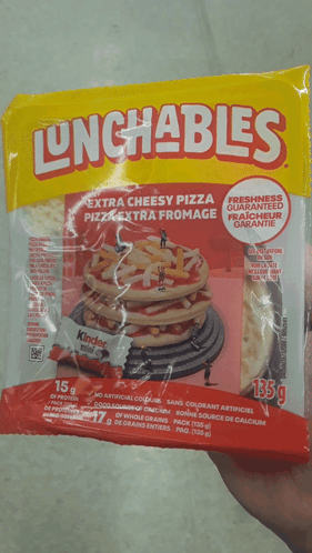 A Person Is Holding A Bag Of Lunchables Extra Cheesy Pizza GIF