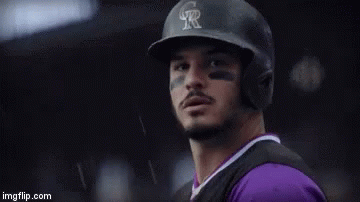 A Person Is Holding A Baseball Glove With The Name Nolan On It GIF