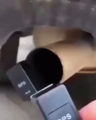 A Person Is Holding A Black Gps Device In Their Hand GIF