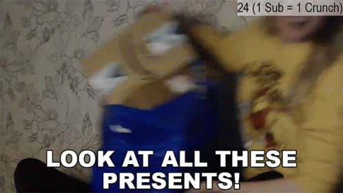 A Person Is Holding A Blue Box With The Words Look At All These Presents Written On It GIF