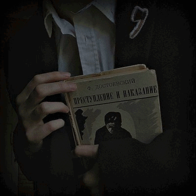 A Person Is Holding A Book With A Picture Of A Shield On It GIF