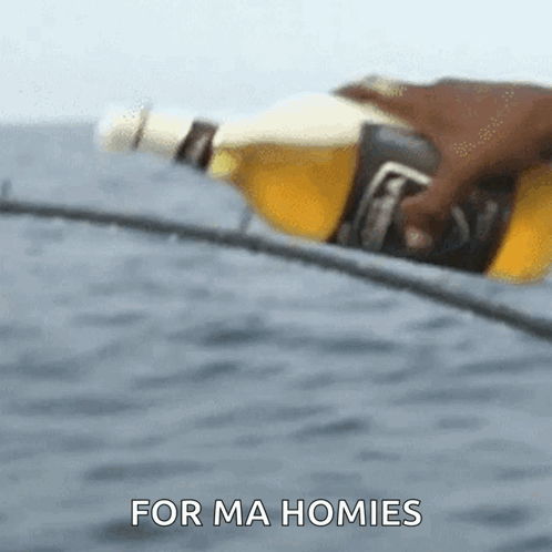 A Person Is Holding A Bottle Of Beer With The Words For Ma Homies Behind Them GIF
