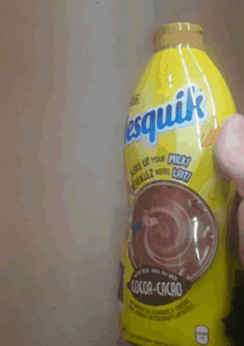 A Person Is Holding A Bottle Of Nesquik Cocoa Cacao GIF