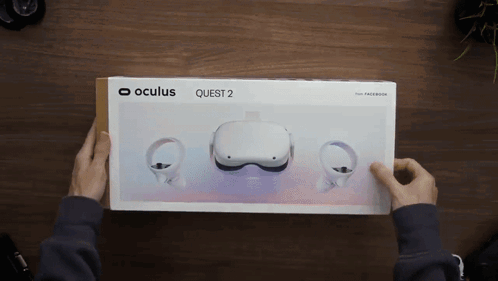 A Person Is Holding A Box That Says Oculus Quest 2 GIF