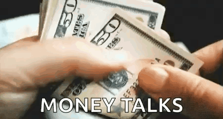 A Person Is Holding A Bunch Of Money In Their Hands And Says `` Money Talks '' . GIF