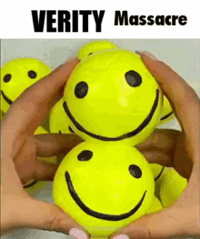 A Person Is Holding A Bunch Of Yellow Smiley Faces In Their Hands .. GIF