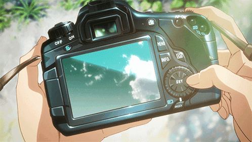 A Person Is Holding A Camera With The Off And On Buttons On The Back GIF