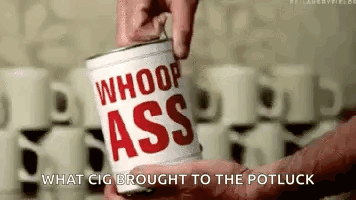A Person Is Holding A Can Of Whoop Ass Coffee . GIF