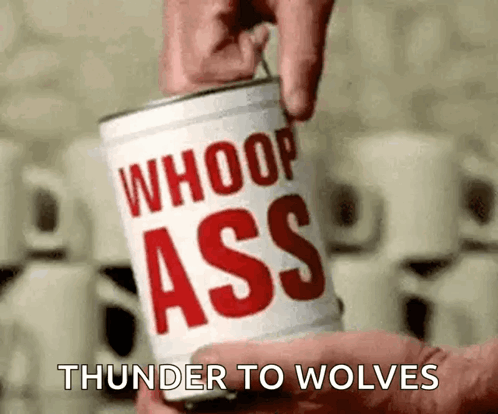 A Person Is Holding A Can Of Whoop Ass Thunder To Wolves . GIF