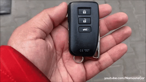 A Person Is Holding A Car Key In Their Hand That Says Ce On It GIF