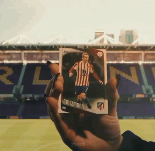 A Person Is Holding A Card That Says Griezmann On It GIF