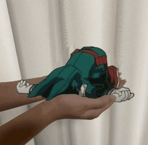 A Person Is Holding A Cartoon Character In Their Palms GIF