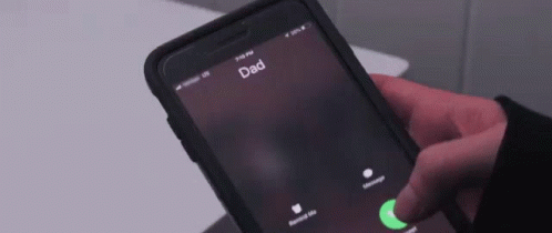 A Person Is Holding A Cell Phone Which Says Dad On The Screen GIF