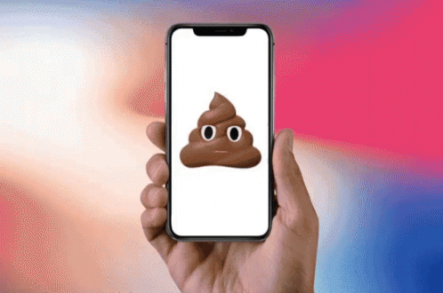 A Person Is Holding A Cell Phone With A Poop Emoji On It GIF
