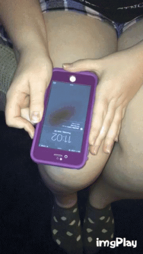 A Person Is Holding A Cell Phone With The Time Of 11:02 On The Screen GIF