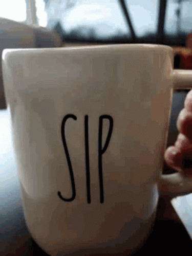 A Person Is Holding A Coffee Cup That Says Sip On It GIF
