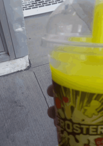 A Person Is Holding A Cup Of Froster Popcorn GIF