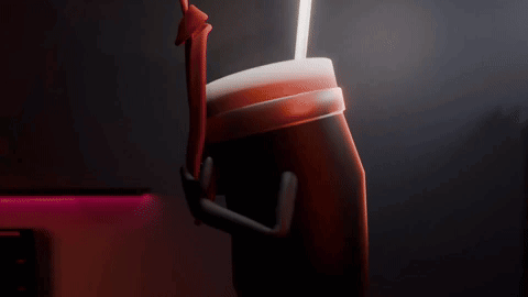 A Person Is Holding A Cup With A Straw In It . GIF