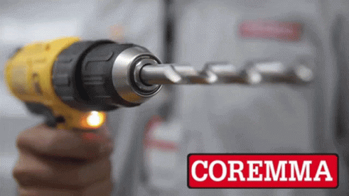 A Person Is Holding A Drill With The Word Coremma On The Bottom Right GIF