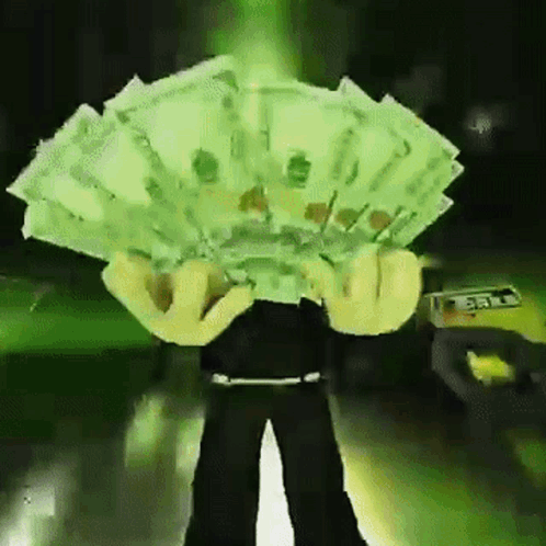 A Person Is Holding A Fan Of Money In Front Of Their Face GIF