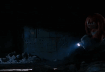 A Person Is Holding A Flashlight In A Dark Room GIF