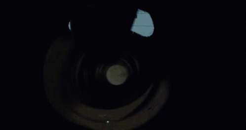 A Person Is Holding A Flashlight Inside Of A Tunnel GIF