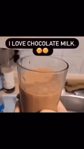 A Person Is Holding A Glass Of Chocolate Milk That Says I Love Chocolate Milk .. GIF