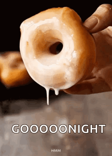 A Person Is Holding A Glazed Donut With Icing Dripping From It And The Words Gooooonight Written Below It GIF