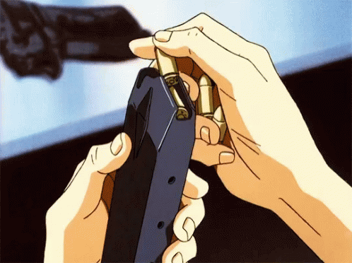 A Person Is Holding A Gun With Bullets In Their Hands GIF