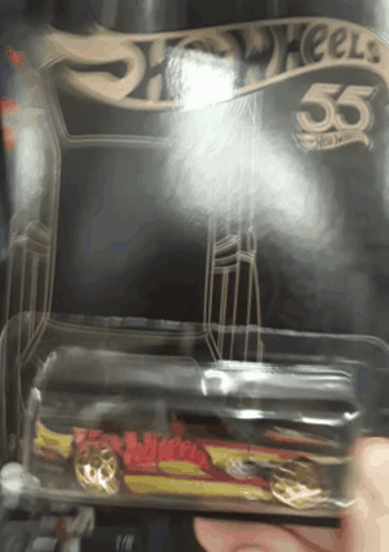 A Person Is Holding A Hot Wheels Car In A Plastic Container GIF