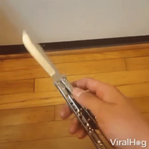 a person is holding a knife with the word viralhog on the bottom left