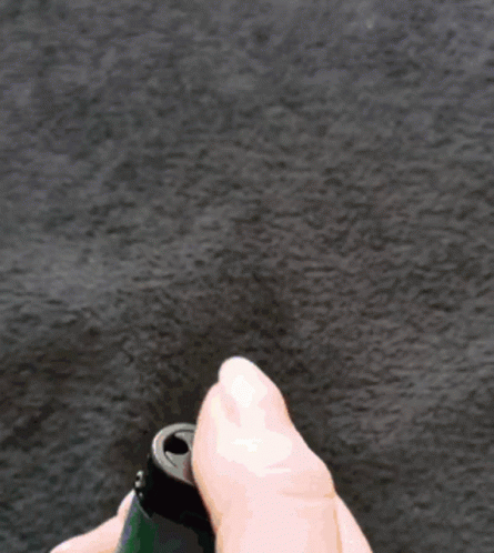 A Person Is Holding A Lighter With A Flame On It GIF
