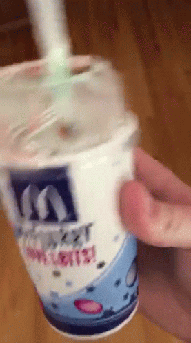 A Person Is Holding A Mcdonalds Cup With A Straw In It GIF