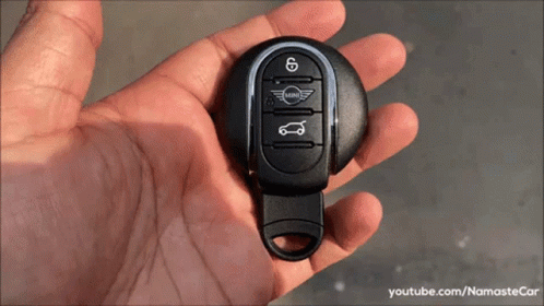 A Person Is Holding A Mini Car Key GIF