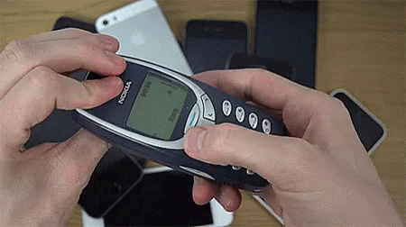 A Person Is Holding A Nokia Cell Phone In Their Hand GIF