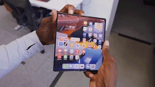 A Person Is Holding A Phone That Says 1:58 On It GIF