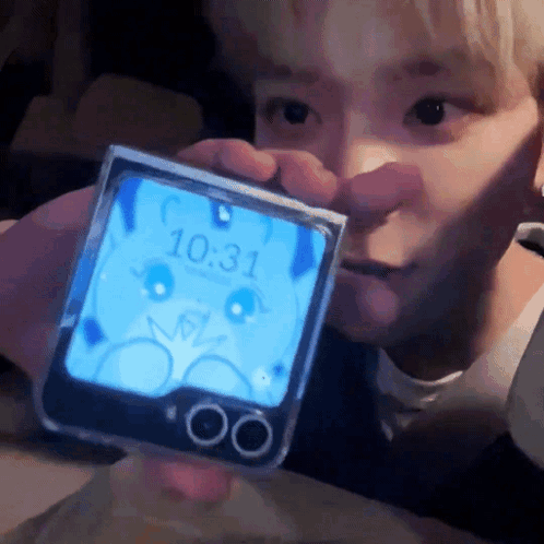 A Person Is Holding A Phone That Says 10:31 On It GIF