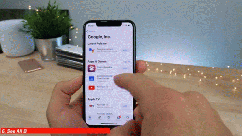 A Person Is Holding A Phone That Says Google Inc. GIF