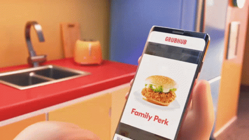 A Person Is Holding A Phone That Says Grubhub On The Screen GIF