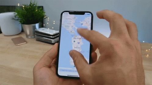 A Person Is Holding A Phone With A Map On It GIF