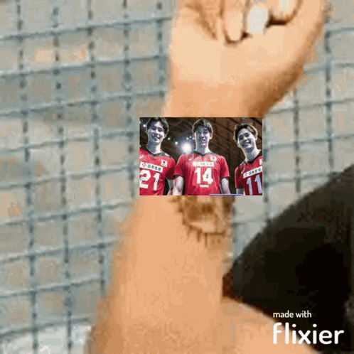 A Person Is Holding A Picture Of Three Volleyball Players With The Number 14 On Their Jersey GIF