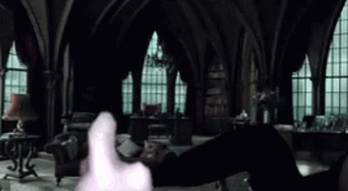 A Person Is Holding A Piece Of Paper In Their Hand In A Dark Room . GIF