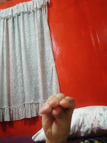A Person Is Holding A Piece Of White Lace On A Red Table GIF