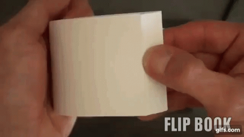 A Person Is Holding A Piece Of White Paper In Their Hands . GIF