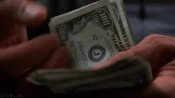 A Person Is Holding A Pile Of Money In Their Hands . GIF